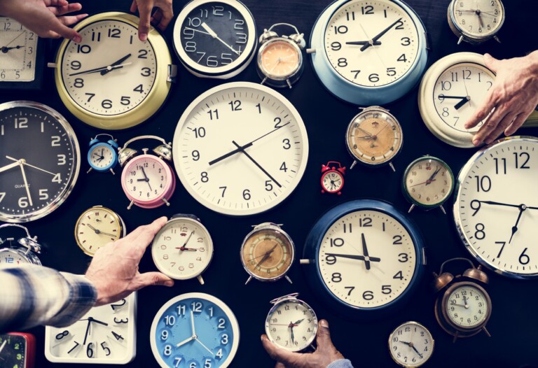 hands holding clocks